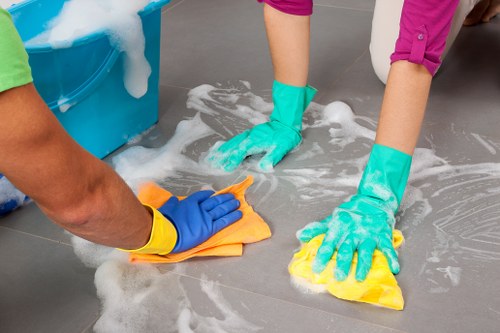 Cleaning staff following safety procedures in a professional workplace